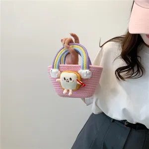Pink woven bucket bag detail featuring rainbow handles, tassels, and an adorable bread plush doll.