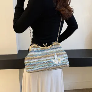 Women fashion woven shoulder bag with floral embroidery and chic metal kiss-lock clasp.