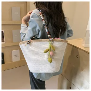 Woven straw tote bag for women, large beach shoulder bag with ribbon handle and knit pendant.