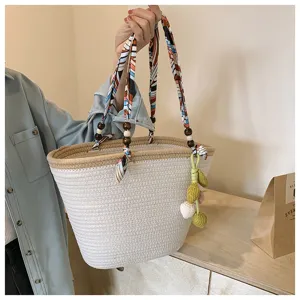 Woven tote bag for women with colorful silk scarf ribbon handle and cute pendant for summer beach.