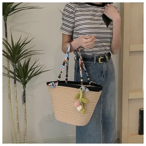 Woven straw tote bag with ribbon handle and knit ball pendant, large capacity beach shoulder bag.
