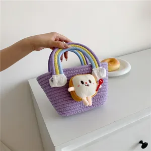 Cute rainbow knitted bucket bag with plush bread doll pendant for women daily use.