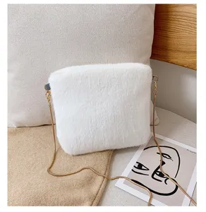 White fluffy plush crossbody bag detail view, soft faux fur shoulder bag with gold chain.