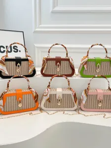 Chic straw woven handbag featuring silk scarf patchwork, stylish box crossbody bag for daily wear.