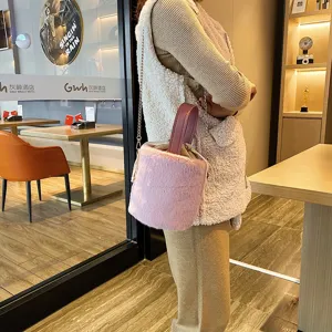 Furry bucket shoulder bag for women, plush winter handbag with chain strap and drawstring.