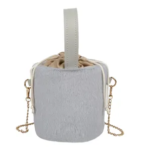 Grey plush bucket bag with top handle and gold chain strap, stylish winter handbag.