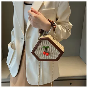 Chic straw woven handbag with brown PU trim and cute cherry charm for women summer style.