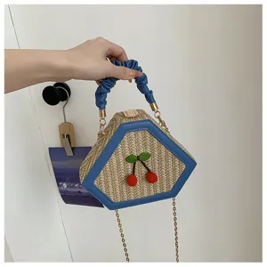 Woven straw handbag with blue ruched handle, cherry decor, and chain strap for women detail