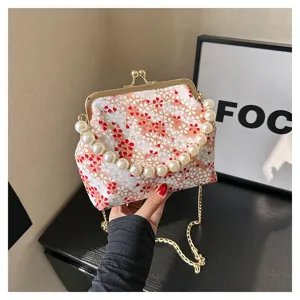 Pearl handle floral kiss lock bag detail view, vintage style evening shoulder handbag.