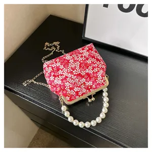 Cherry blossom print kiss-lock handbag with pearl handle and chain strap for women.