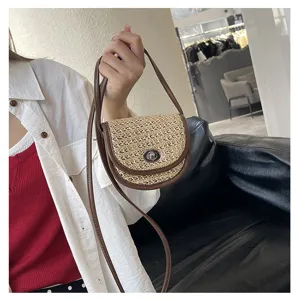 Mini straw woven crossbody bag with brown leather trim and metal lock closure for women.