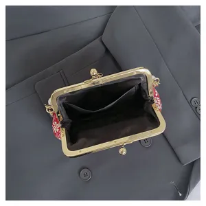 Close-up interior view of vintage floral kiss-lock clutch bag showing lining pockets detail.
