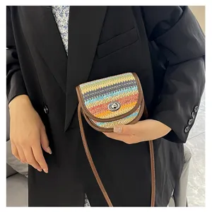 Mini colorblock woven crossbody bag featuring textured fabric, brown trim and metal turn-lock clasp.