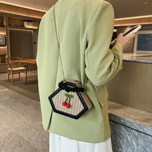 Fashion hexagonal woven straw crossbody bag with chic pleated handle and cute cherry accent.