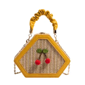 Chic straw crossbody bag for women with cute cherry decor, pleated handle, and stylish design.
