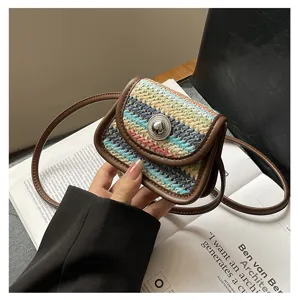 Details of stylish mini woven crossbody bag with color-matching design and leather trim.