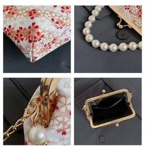 Elegant women floral kiss lock handbag with pearl handle and metal frame detail view.
