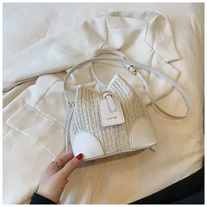 Summer woven bucket bag for women stylish straw shoulder handbag with chic PU leather details.