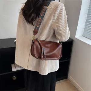 Soft leather brown shoulder crossbody bag with wide ethnic strap for women casual daily use.