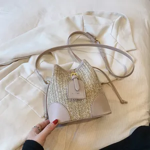 Woven straw bucket bag for women, stylish summer shoulder bag with PU leather patchwork.