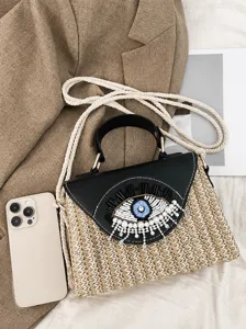 Summer woven straw handbag with beaded eye design, top handle and crossbody strap bag.