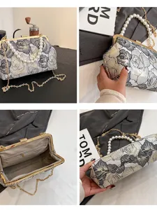 Elegant vintage floral jacquard kiss lock handbag with pearl handle and gold chain strap.