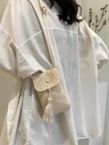Summer straw woven mini crossbody phone bag with tassel and magnetic flap for women.