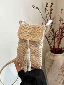 Summer straw woven mini crossbody phone bag with stylish tassel and magnetic flap closure.