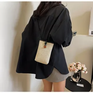 Chic woven straw phone bag for women, stylish crossbody mini pouch with drawstring closure.