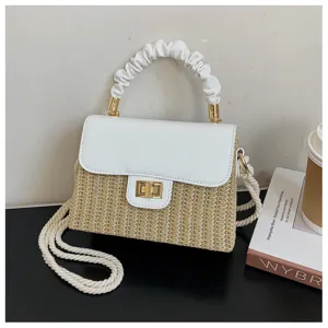 Chic straw woven shoulder bag with white PU leather flap, twisted handle, and gold lock.