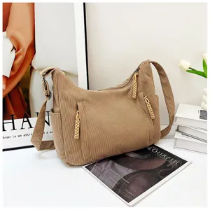 Detailed view of casual corduroy shoulder bag with side pockets and braided zipper pulls.
