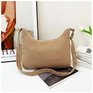 Corduroy shoulder bag detail shot in khaki color, featuring wide strap and soft textured fabric.