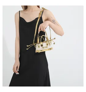 Mini straw top handle crossbody bag for women, chic metallic gold trim summer fashion purse.