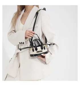 Detail view of niche design straw colorblock mini handbag, chic shoulder crossbody bag for summer.