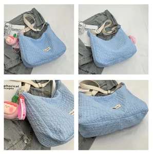 Light blue crinkled hobo shoulder bag with cute peach pendant, casual dumpling crossbody bag.