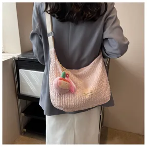 Cream crinkle shoulder crossbody bag, cute bubble tote dumpling style with plush charm detail.