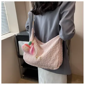 Pink pleated bubble shoulder crossbody bag for women, cute dumpling tote bag with plush charm.