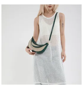 Chic straw hobo shoulder bag with green leather trim, stylish crescent design for summer.