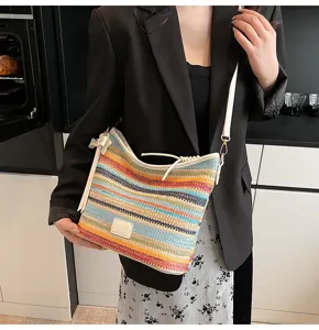 Detailed view of colorful striped woven shoulder bag, casual chic straw bucket bag.