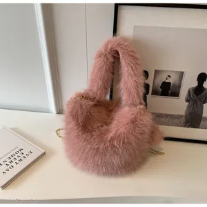 Chic pink plush handbag with gold chain strap, stylish fuzzy crossbody bag for women daily wear.