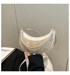 Stylish straw shoulder bag with crescent design and white leather trim for beach and daily wear.