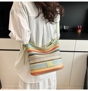 Detail view of the colorful woven shoulder bucket bag, featuring stylish striped patterns.