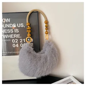 Grey plush shoulder bag detail, featuring wooden bead handle and soft faux fur texture.