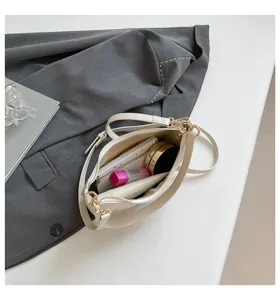 Stylish women underarm crescent straw bag, versatile casual shoulder bag for beach use.