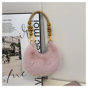 Detailed view of pink plush crescent shoulder bag with stylish wooden bead handle.