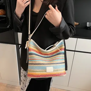 Stylish color-block woven shoulder bag for women, trendy casual bucket bag for spring daily use.