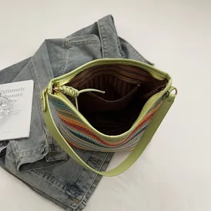 Colorful woven shoulder bag for women, stylish bucket bag with PU strap and spacious interior.