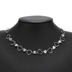 Detailed view of silver stainless steel hollow heart chain necklace, delicate jewelry accessory.