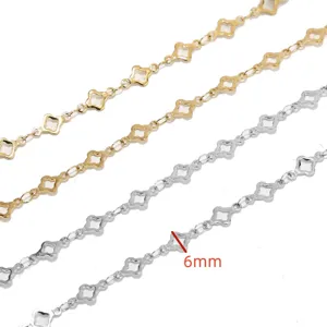 Close-up detail of stainless steel clover chain featuring 6mm links in gold and silver finish.