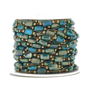 Beaded chain spool with gold links and teal rectangular crystal beads for DIY jewelry making.